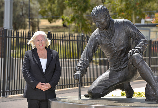 Professor Robyn Clark next to Matthew Flinders statue at Railway Station