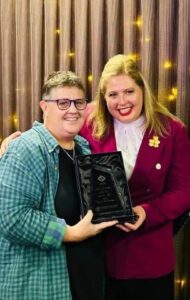 Kerry Beck (left) accepting her award with Katrine Hildyard MP (Minister for Child Protection Minister for Women and the Prevention of Domestic and Family Violence)