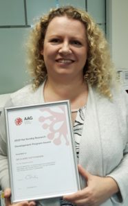 Dr Claire Hutchinson holds her award certificate