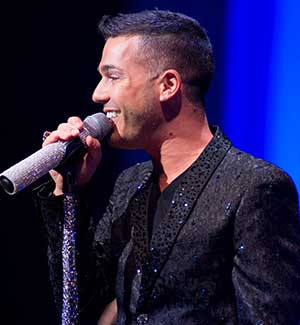Pop Star Anthony Callea holding the microphone as he belts out a tune.