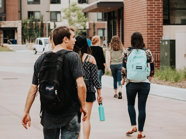 A group of young people walking next to apartment blocks