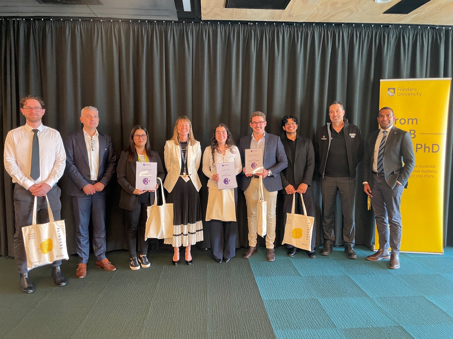 2026 University Finalists: (from left to right), Michael Kirton (Finalist), Tim Cavagnaro (MC, PVC Research Training and Capabilities and Dean of Graduate Research), Rajani Khanal (University Runner-Up), Professor Tracey Humphrey (Judge), Stellene Vitaro (University Winner), Samuel Doering (University People’s Choice Winner), Jay Verma (Finalist), Mr Jim Deed (Judge), Mr Benson Saulo (Judge).