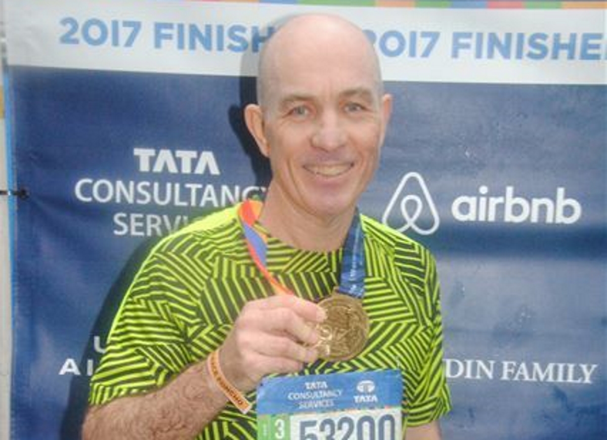Professor Tim Carey with his participation medal