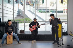 Flinders University international students performing a song on stage