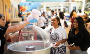 two female students buying fairy floss at flinders university orientation week.
