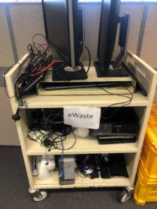 library trolley being used to corral discarded electronic items for e-waste disposal