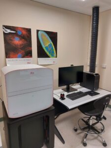 The Leica Mica confocal microscope in a room next to a computer on a desk.